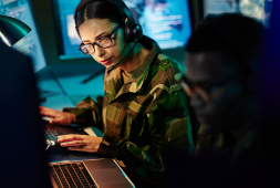 Military analyst working at a workstation.