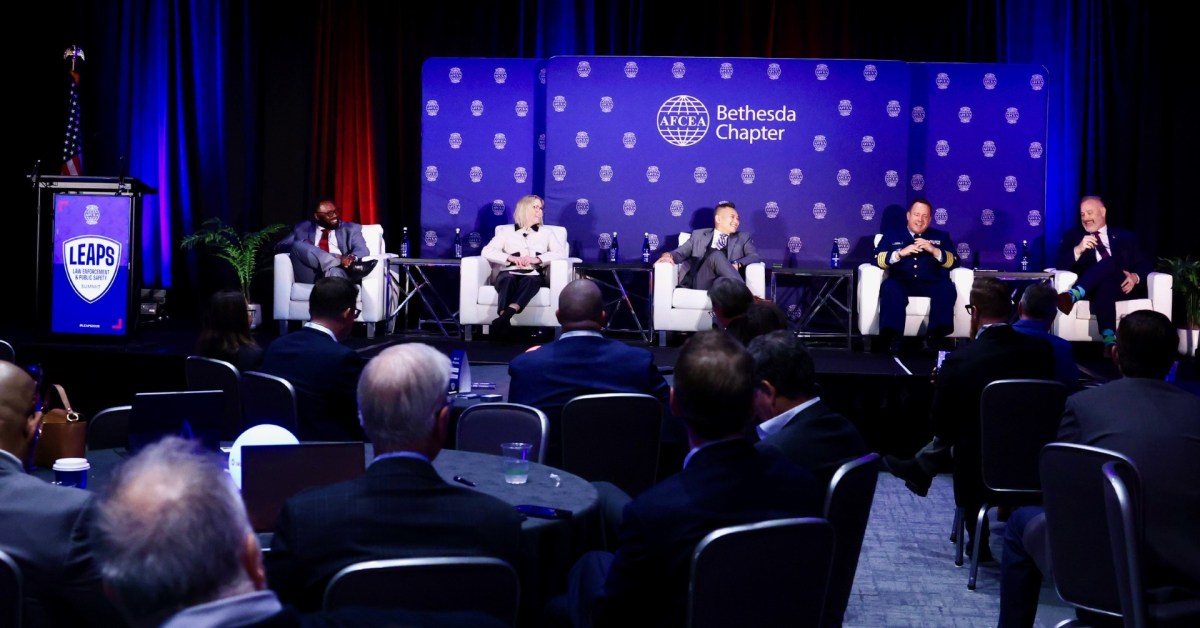 Professionals on stage during a panel discussion.